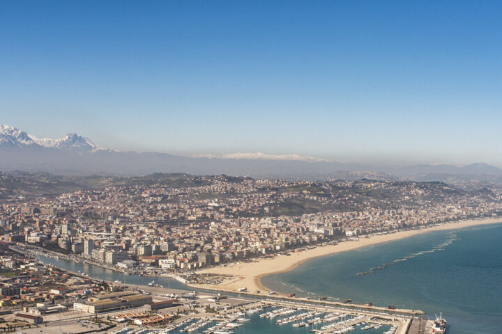 Pescara vista dall'alto con il mare, il lungomare, il porto canale e in lontananza colline e montagne