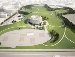 Rendering del progetto di riqualificazione di Piazza d’Armi all’Aquila: ampie aree verdi, percorsi pedonali curvilinei e spazi sportivi integrati, con al centro una struttura circolare di nuova costruzione destinata a funzioni pubbliche e ricreative