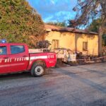 L’incendio, partito all’esterno, ha distrutto suppellettili, un’auto e alberi prima di propagarsi all’interno del fabbricato comunale, rendendolo inagibile. Sul posto vigili del fuoco, sindaco e Carabinieri
