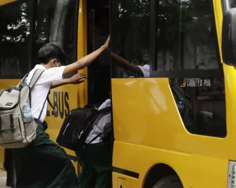 Un gruppo di studenti sale a bordo di uno scuolabus